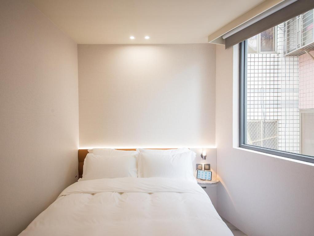 Postel nebo postele na pokoji v ubytování LIVIN Hotel