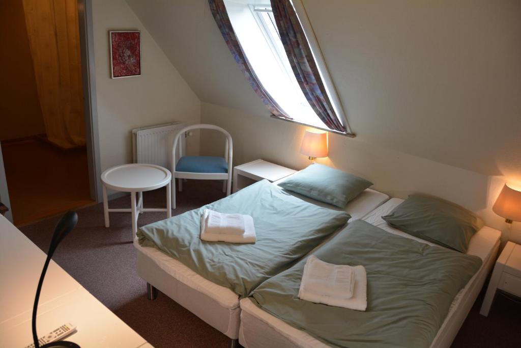 Postel nebo postele na pokoji v ubytování Abild Hotel