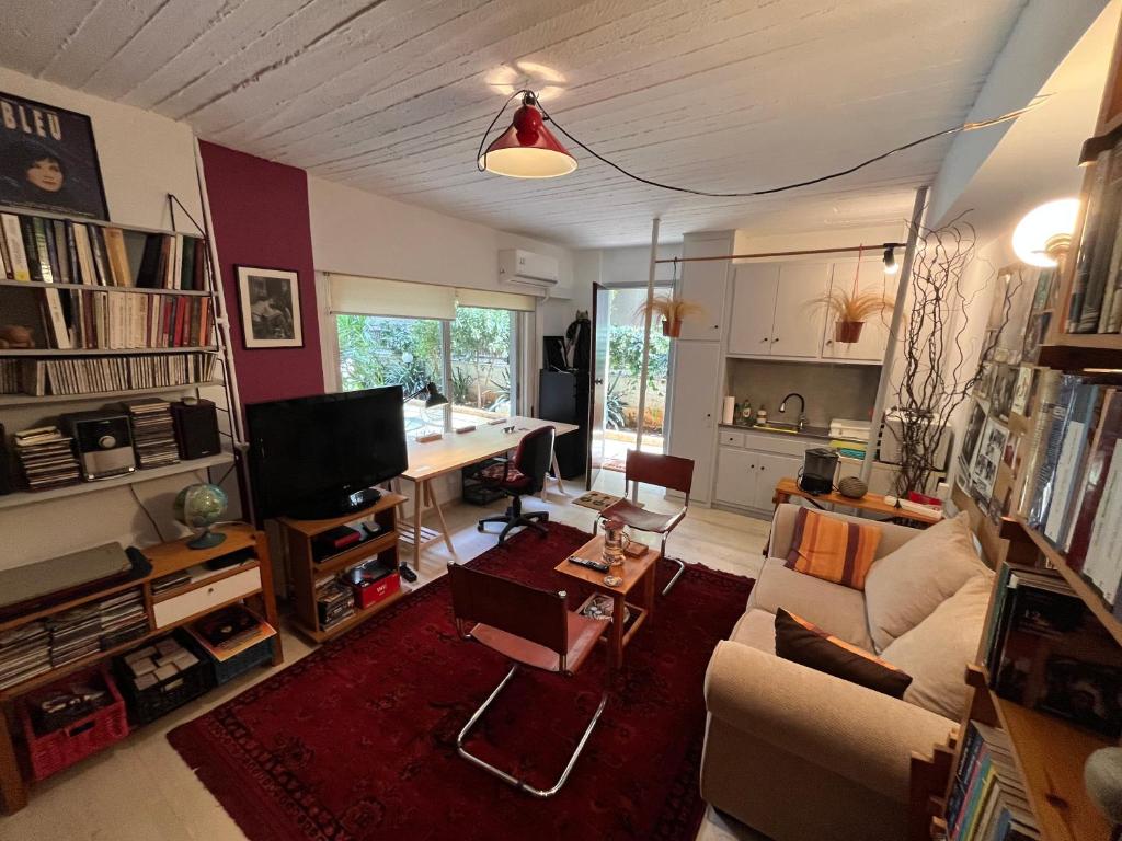 a living room with a couch and a table at Cozy quiet studio near the sea in Athens