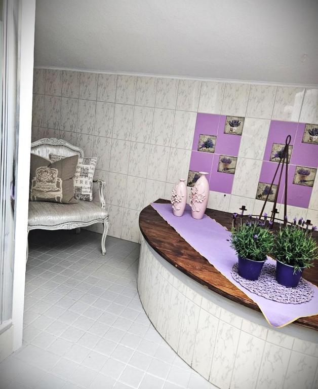 a room with a bed and a bench with plants at FeWo Südfrankreich in Neue Scheune
