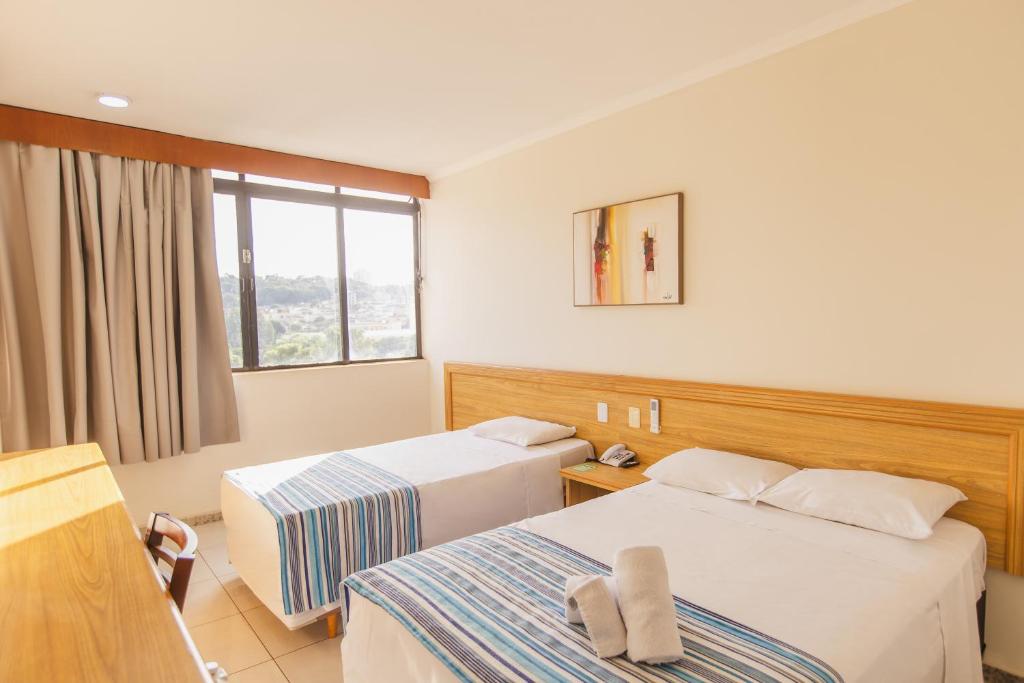 Кровать или кровати в номере Hotel Nacional Inn Ribeirão Preto