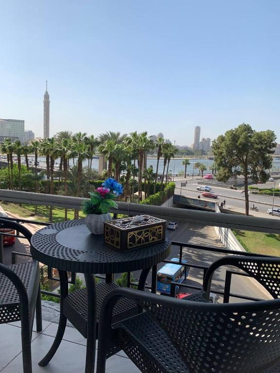 a table and chairs on a balcony with a view at Garden City inn Hotel in Cairo