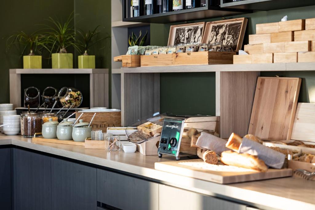 a bakery counter with bread and other items on it at Vision Hotel in Peschiera del Garda