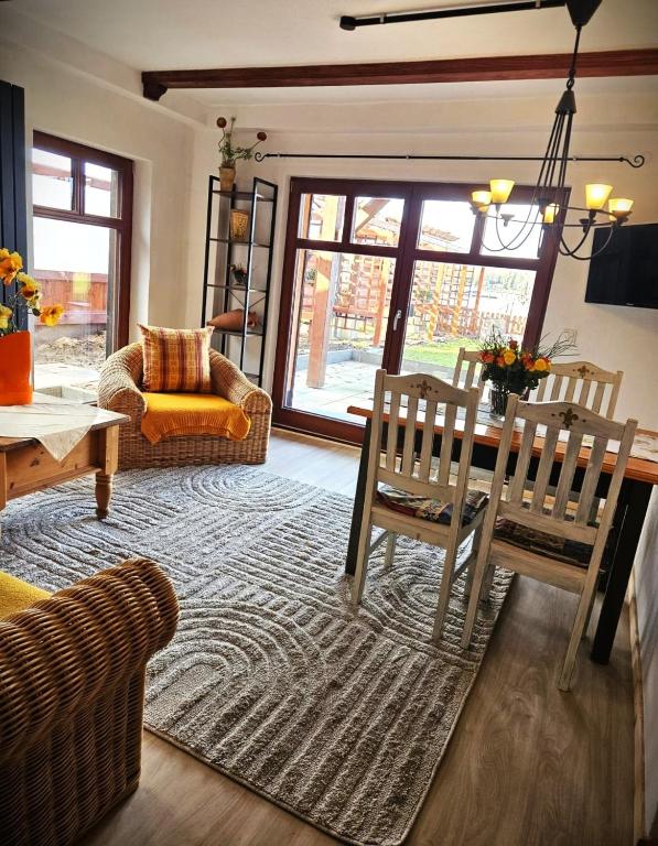 a living room with a dining table and chairs at FeWo Mallorca in Neue Scheune