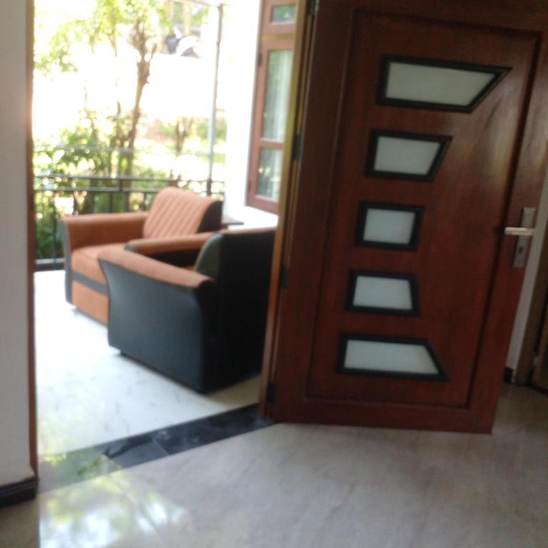 a door leading into a living room with a couch at Gagana vila in Katugastota