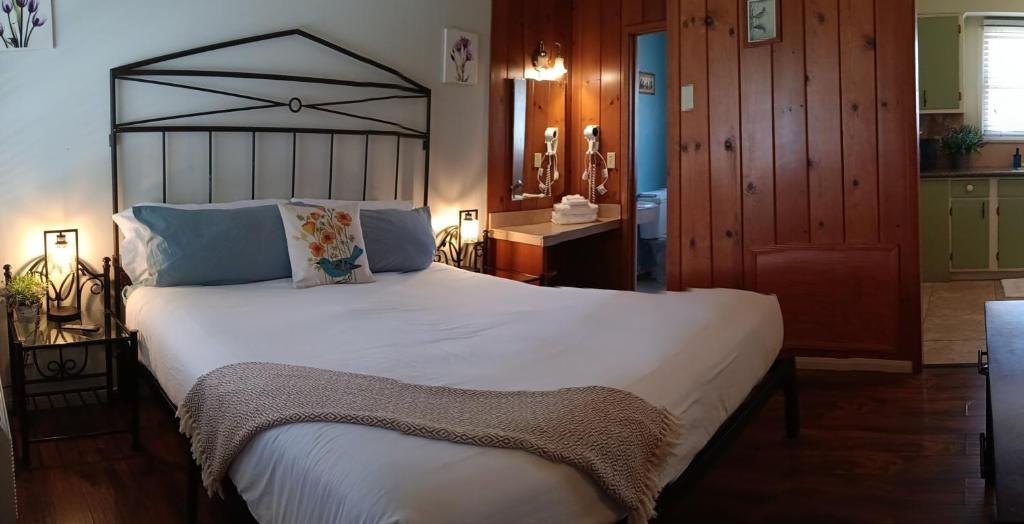 a bedroom with a large white bed in a room at Trees Motel in Bishop