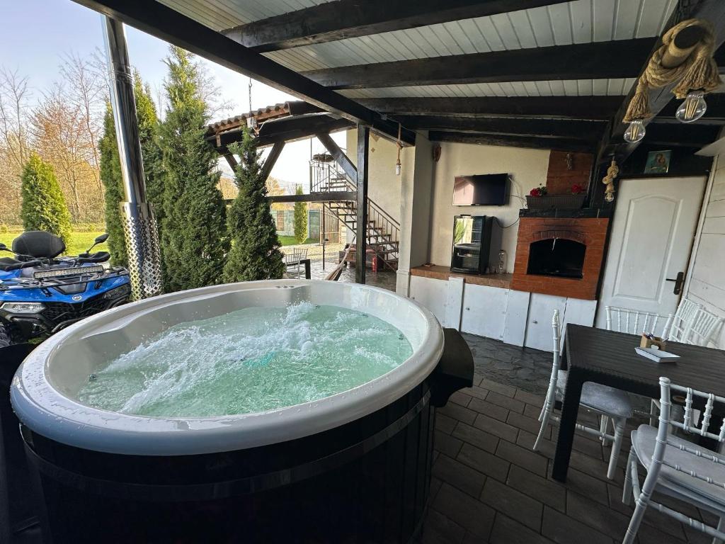 a jacuzzi tub on the patio of a house at Cabana Diana in Avrig