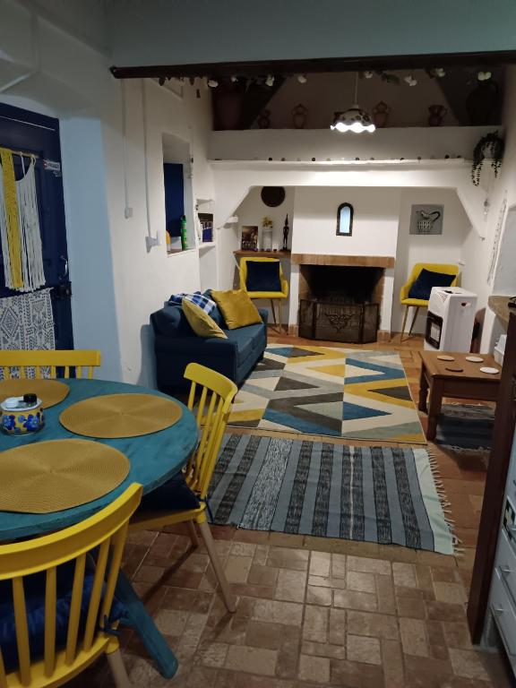 a living room with a table and a couch at Blue&YellowHouse in Alcoutim