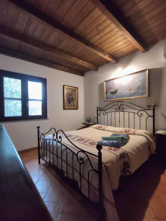 a bedroom with a metal bed in a room at Casa Francesca in Costa Rei