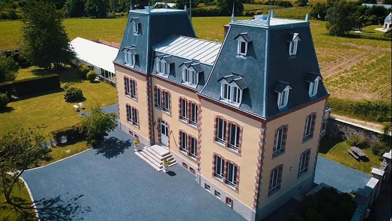 an aerial view of a large house with a roof at Château de Montmireil in Canisy