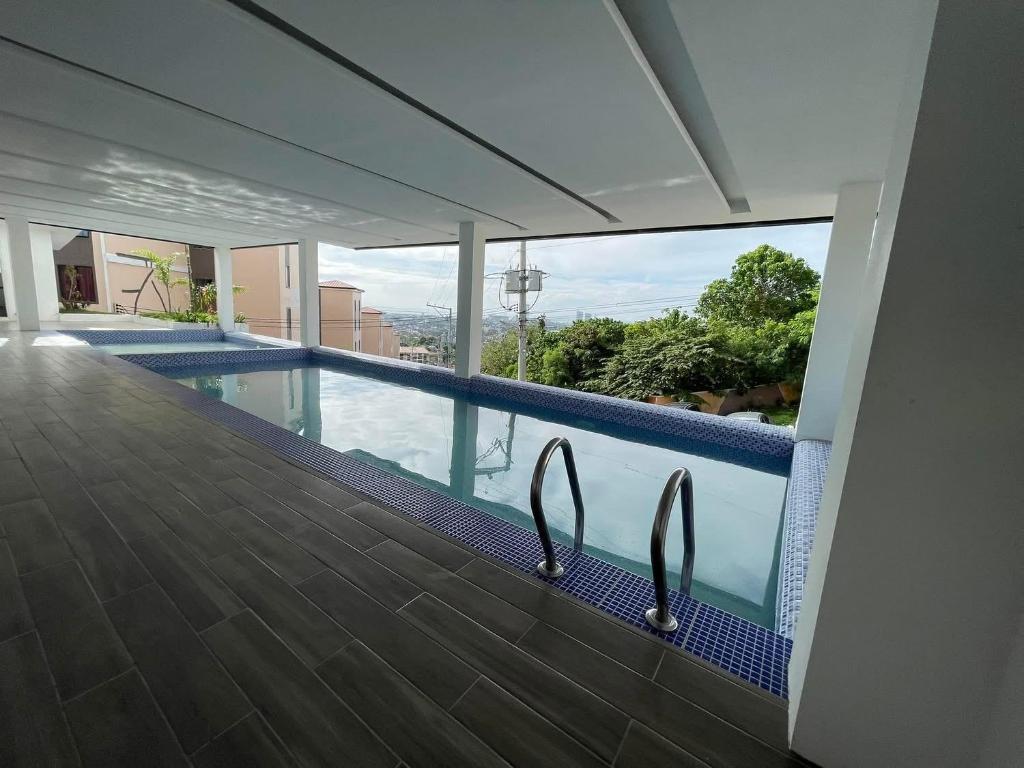 a swimming pool with a view of a building at Golden Poppy Cozy Condo in Cebu City