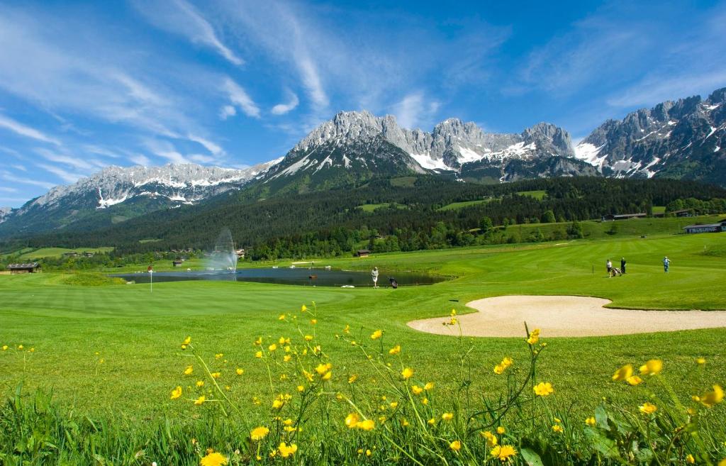a golf course in a field with mountains in the background at Appartements Schedererhaus in Going am Wilden Kaiser