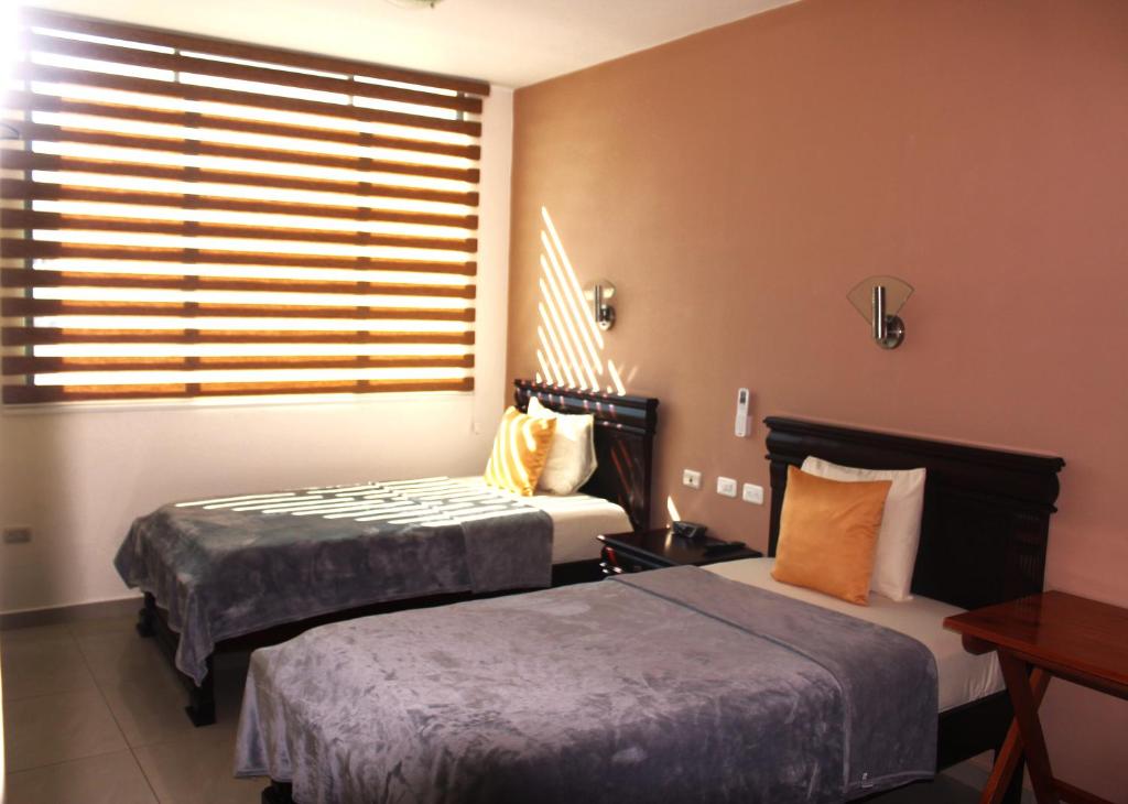 Postel nebo postele na pokoji v ubytování Hotel Flamingo