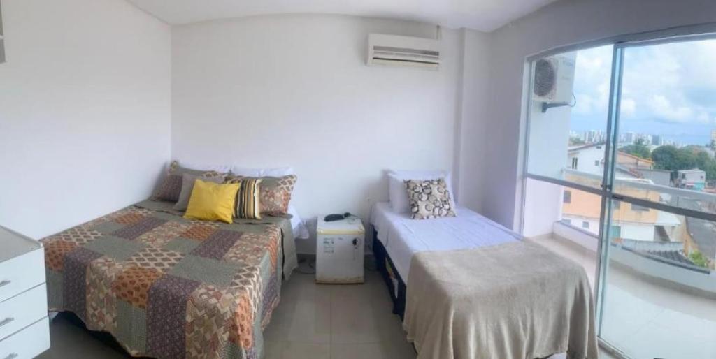 En eller flere senge i et værelse på Pousada Aliança