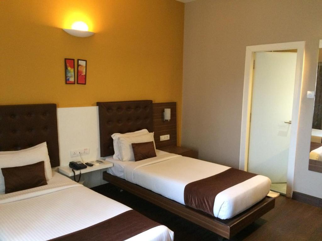 Postel nebo postele na pokoji v ubytování Mango Hotels Prangan