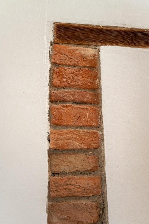 a corner of a brick wall with at Artistica Pienza - Breathtaking Val d'Orcia View in Pienza