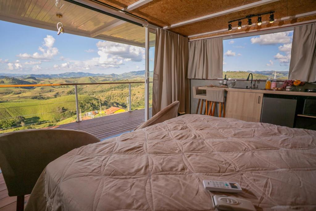a bedroom with a bed and a large window at Cabana bela vista in Cunha