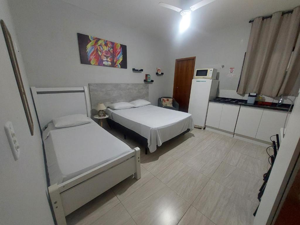 Postel nebo postele na pokoji v ubytování Kitnets bem localizada, próx ao autódromo!