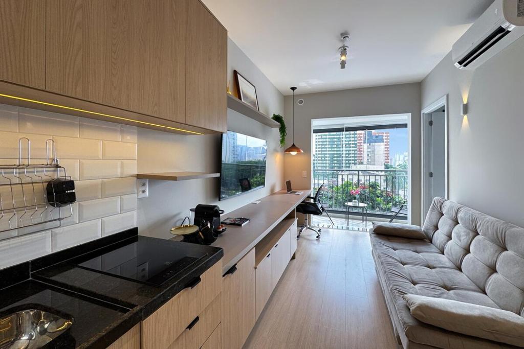 a living room with a couch and a kitchen at Smart Home in Sao Paulo