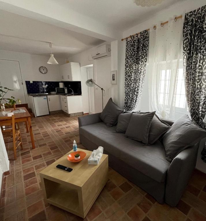 a living room with a couch and a table at Casa Patricia II in Arcos de la Frontera