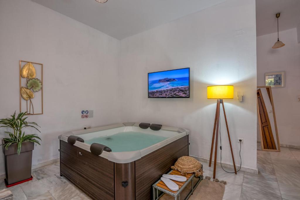a bathroom with a bath tub in a room at Achilleas Deluxe House-Jacuzzi - BBQ in Kotsianá
