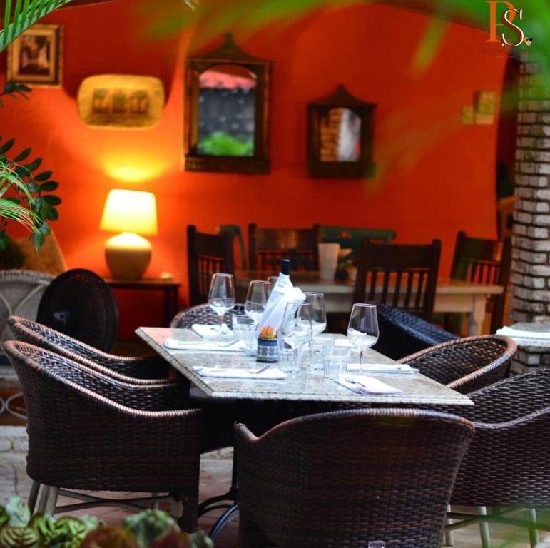 a table in a restaurant with wine glasses on it at Escape en terrazas del caribe con psicina y playa in Boca Chica
