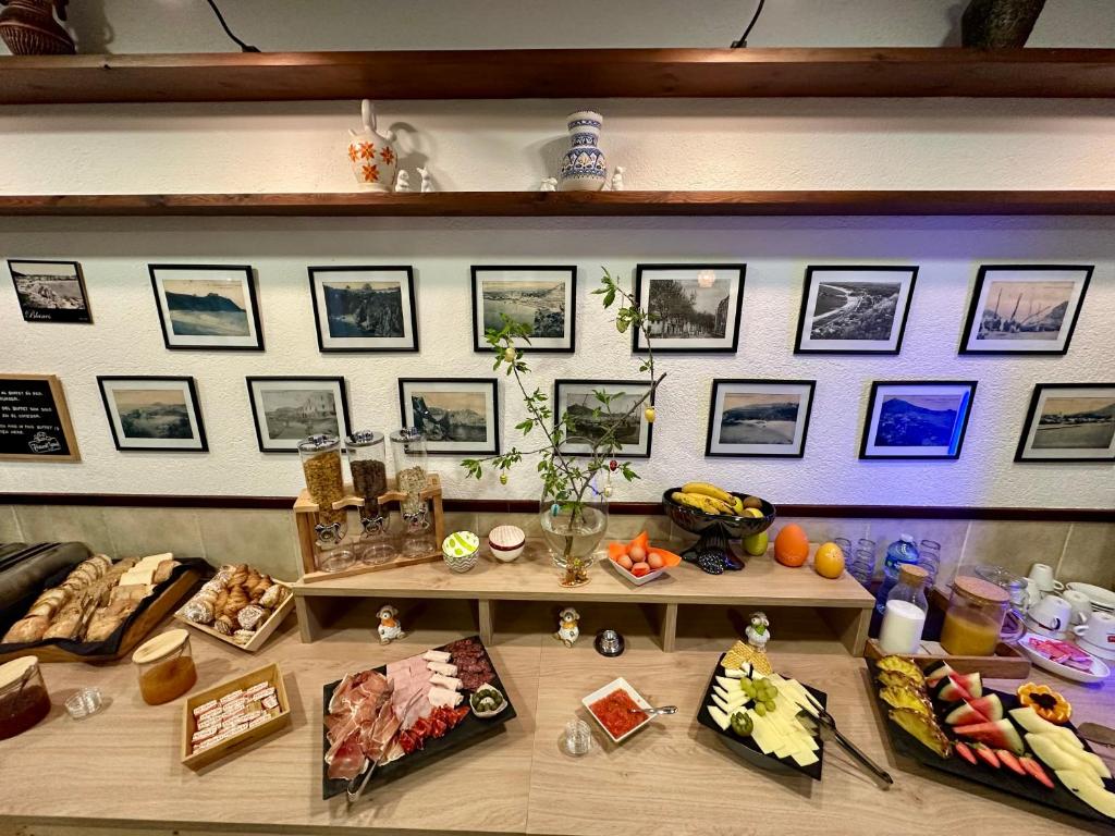 a display of food on a shelf with pictures on the wall at Hostal Regina in Blanes