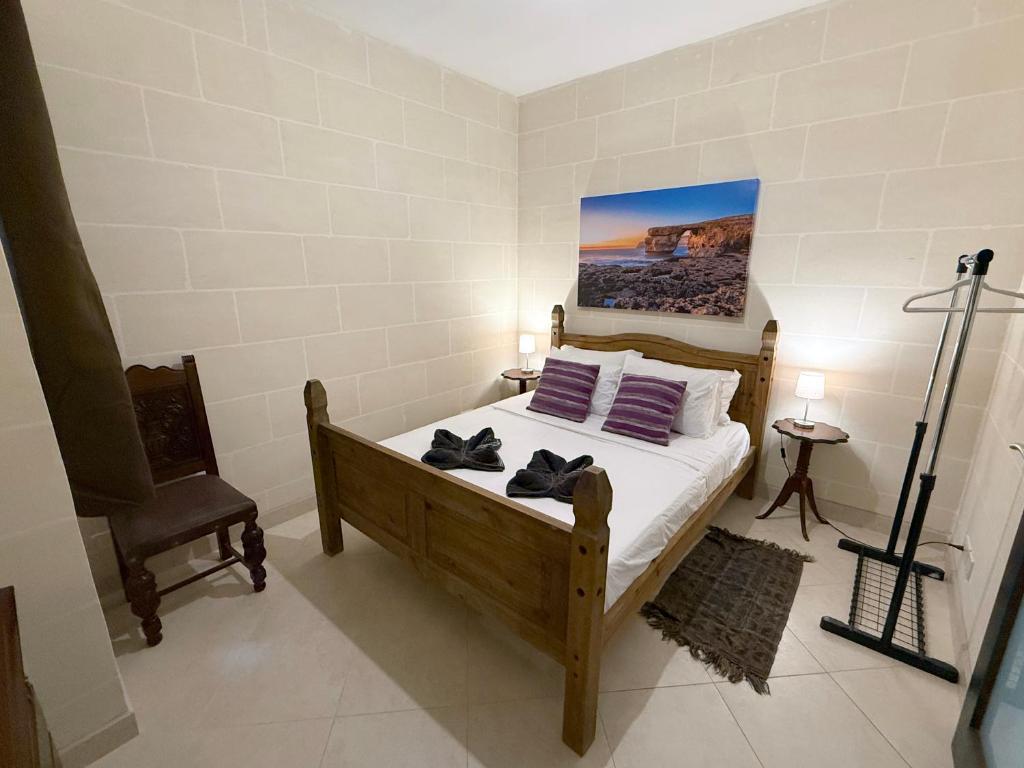 a bedroom with a bed with purple pillows on it at Seashell Stories - Modern Comforts, Traditional Charm in Nadur