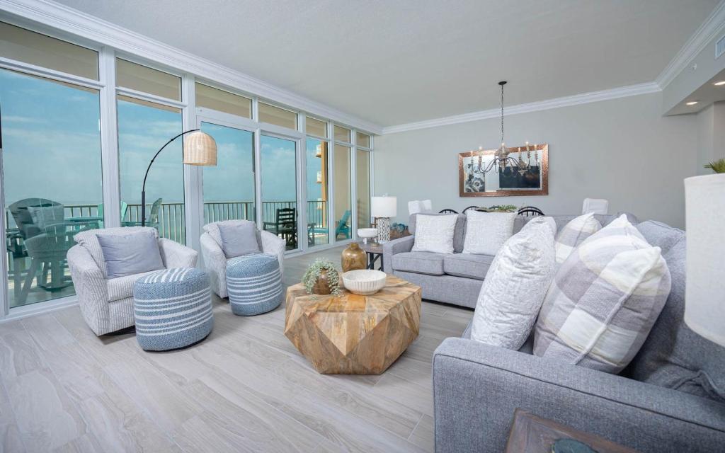a living room with two couches and a table at Phoenix Gulf Towers 806 condo in Gulf Shores