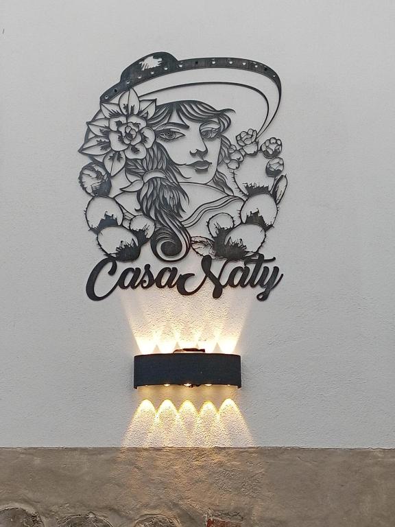 a sign for a casa salsa ally on a wall at Casa Naty in Mexico City