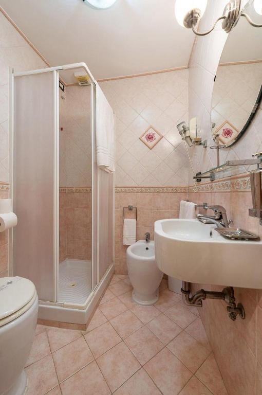 a bathroom with a toilet and a shower and a sink at Sancta Scala in Rome