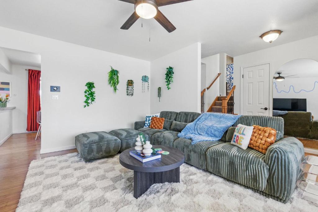 a living room with a couch and a table at Spacious 4BD - Backyard BBQ, Fire Pit & Mini Golf in Arvada