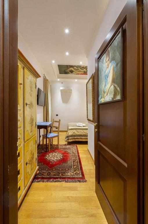 a hallway with a door to a room with a bedroom at Sancta Scala in Rome