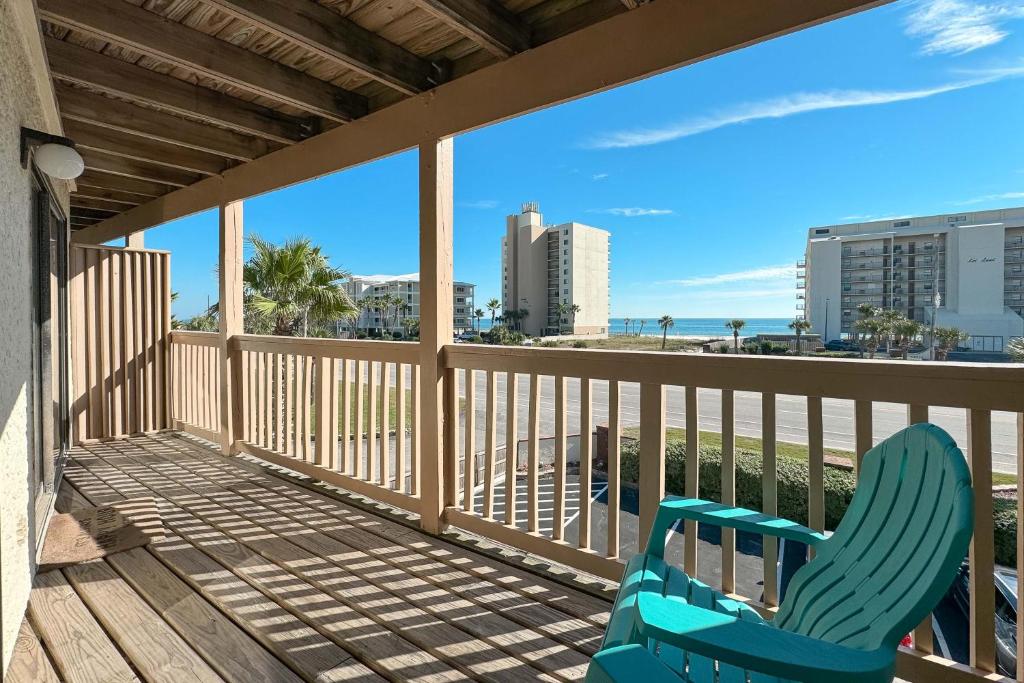 a blue chair on a balcony with a view of the beach at Lei Lani Minit Tower Unit 219 in Orange Beach