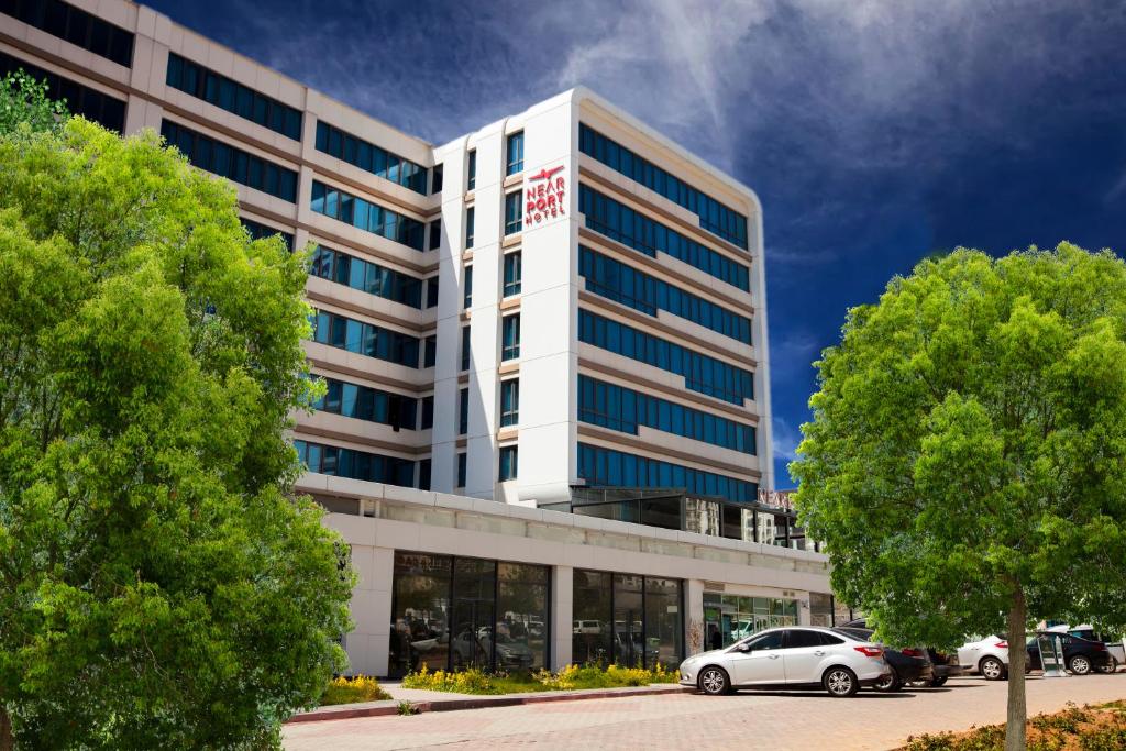 an office building with cars parked in front of it at Nearport Hotel Sabiha Gokcen Airport in Istanbul