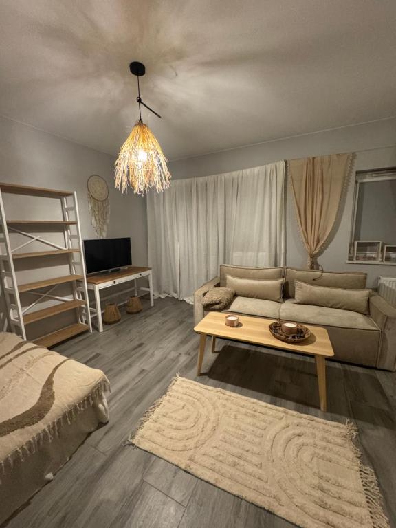 a living room with a couch and a table at Apartament Lux Nowe Ogrody 2 Poznań 24 H Lotnisko Airport in Poznań