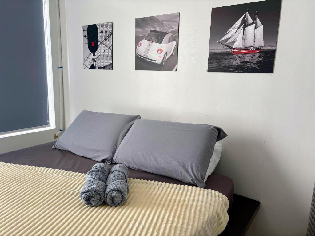 a bedroom with a bed with some pictures on the wall at Casa Manawari in Tagaytay