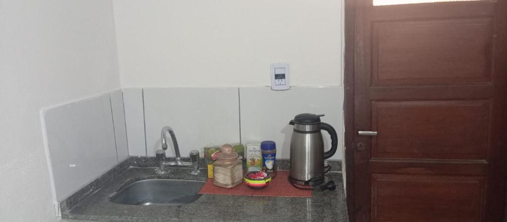 a kitchen counter with a sink and a coffee maker at Don Rufino in Cruz del Eje
