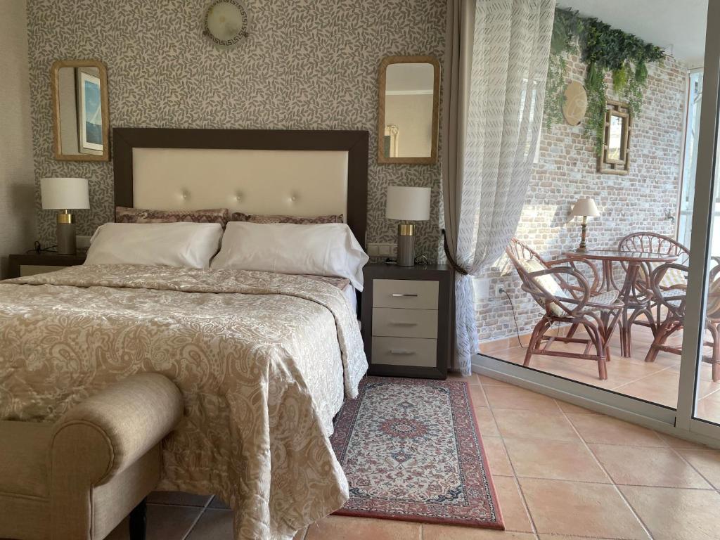 a bedroom with a bed and a table and chairs at Marbella Apartment in Marbella