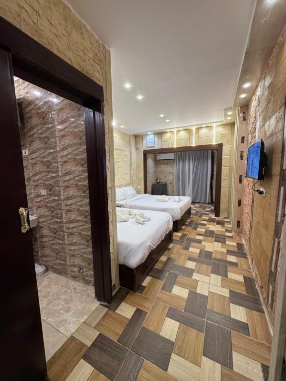 Postel nebo postele na pokoji v ubytování Vida Pyramids Inn