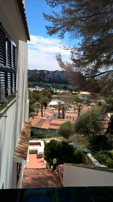 a view of a garden from a building at Apartamentos Encanto Del Mar in Cala Galdana