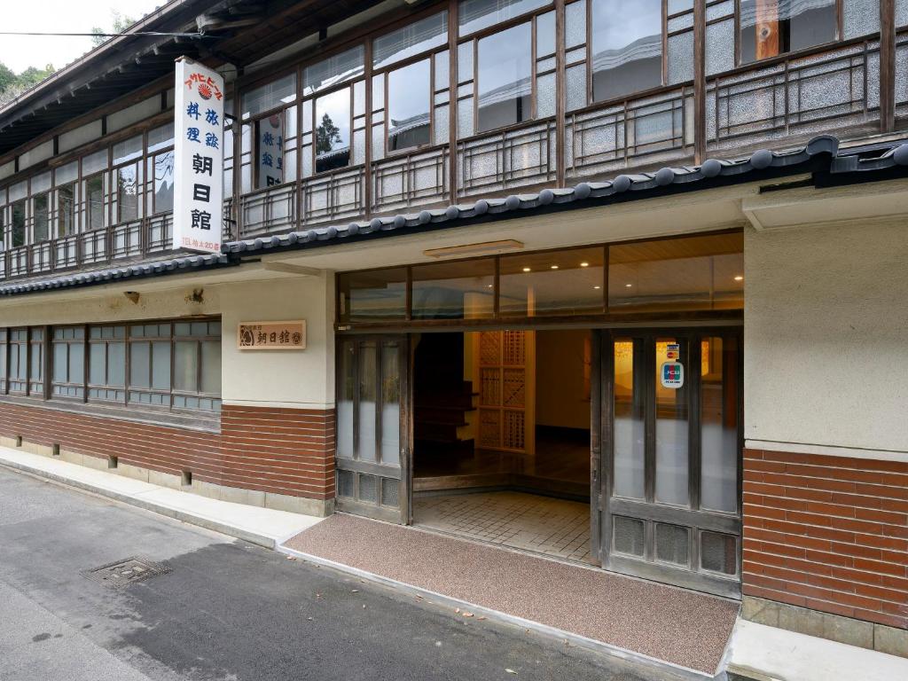 an entrance to a building on a street at Ryouriryokan Asahikan in Shionoha