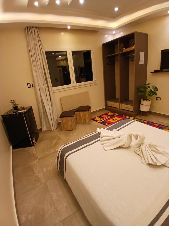 a bedroom with a large bed in a room at pyramids view suite/vista piramidi in Cairo