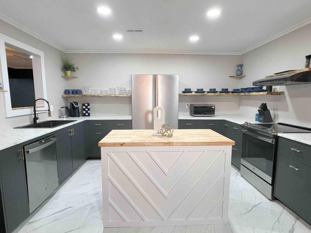 a large kitchen with a stainless steel refrigerator at Family Retreat Prime Location in Decatur in Decatur