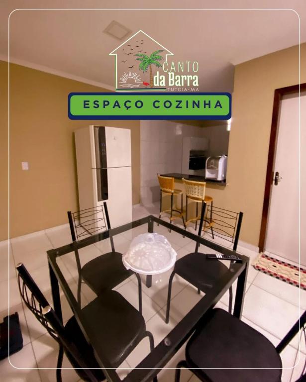 a dining room with a glass table and chairs at Canto da Barra Tutoia in Tutóia