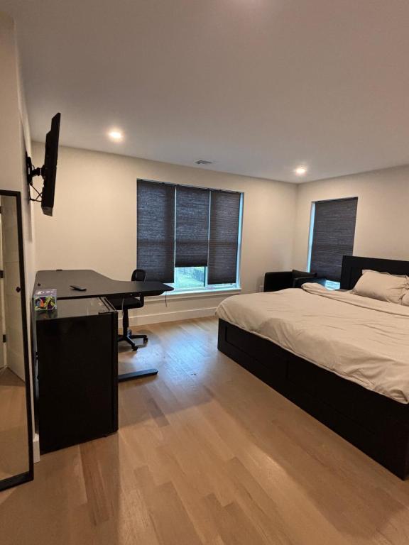 a bedroom with a bed and a desk and window at Modern bedroom in Weymouth with private bath in Weymouth