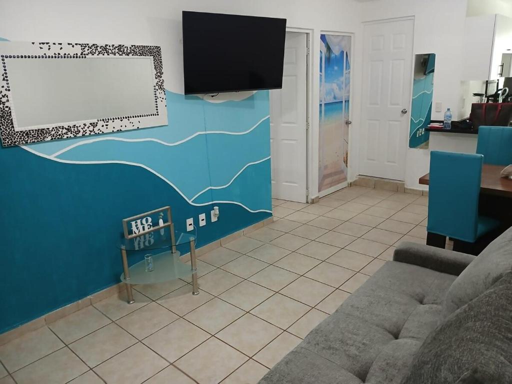 a living room with a couch and a flat screen tv at Authentic and Lindo Departamento in Puerto Vallarta