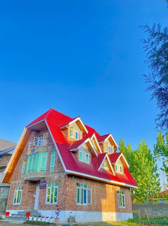 a house with a red roof on top of it at Al Jalal Resort in Srinagar