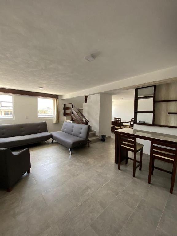 a living room with a couch and a table at Hotel Estrella Apt B in Zacatlán