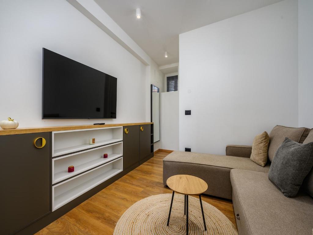 a living room with a couch and a flat screen tv at Room in Porec by Old Town & Waterfront in Poreč